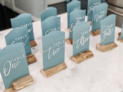 Wedding Table Decorations Beach Theme, Seaglass Seating Chart, Table Numbers Beach Wedding, Sea Glass Table Numbers, Seaglass Wedding Centerpieces, Beachy Wedding Centerpieces, Sea Glass Blue Wedding, Seaglass Wedding Decor, Blue Table Numbers Wedding