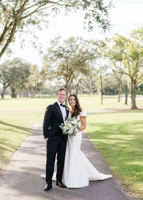 The bride was breathtaking in her off the shoulder, button back silk trumpet style gown and adorable white bow shoes at this Palm Ceia outdoor wedding. The groom and his groomsmen were handsome in their traditional black tuxedos. Events in Bloom artfully designed white bouquets with greenery accents for the bridal party as well as coordinating centerpieces. This Events by Lindsay J. wedding was the definition of classic romance. Hunter Ryan Photo Traditional Wedding Poses, Wedding Photography Shot List, Chapel Length Veil, Wedding Portrait Poses, V Neck Wedding Dress, Traditional Bride, Groom Photo, Bride Photo, Romantic Bride