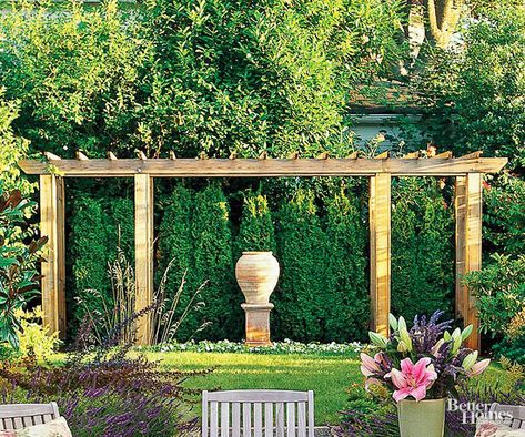 Create a focal point in your backyard with a decorative pergola. This pergola adds depth and dimension to the lushly landscaped yard and provides a framework for one of the owners' favorite sculptures. Decorative Pergola, Dream Backyard Garden, Pergola Curtains, Backyard Garden Layout, Pergola Ideas, Backyard Garden Landscape, Vegetable Garden Planning, Building A Pergola, Modern Pergola