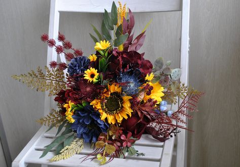 This beautiful burgundy navy blue sunflower bouquet is perfect for your fall boho wedding,rustic wedding, burgundy wedding. Mixture of silk flowers burgundy,navy blue flowers ,orange and yellow.  Handle tied wildflower bouquetwith velvet ribbon. Fall wedding flowers cascading bouquet availablein size: bridal  bouquet 13'',bridesmaid bouquet 9'', toss bouquet 4''. Is made of high quality artificial flowers and greenery. The colors may slighty differ due to your screen settings. Navy Blue Wildflower Wedding, Navy Blue Burgundy Sunflower Wedding Decor, Navy Burgundy Wedding, Fall Sunflower Weddings, Rustic Bridal Bouquet, Deep Red Wedding, Yellow Wedding Decorations, Purple Fall Wedding, Wedding Flavors