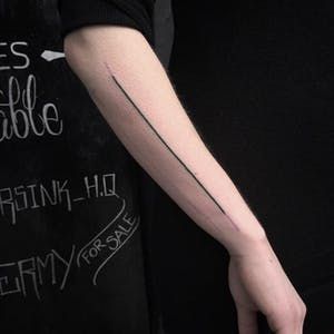 The Skill of the Single Black Line Tattoo | Tattoodo Straight Line Tattoo, Line Tattoo Arm, Black Line Tattoo, Minimalistic Tattoos, Graphic Tattoo, Line Tattoo Ideas, Single Line Tattoo, Armband Tattoo Design, Body Tattoo