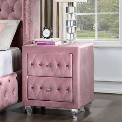 Glam it up. This nightstand features soft, velvety pink fabric that covers the solid and engineered wood frame, while diamond detailing and sparkling crystal-like acrylic buttons and drawer pulls make this piece stand out in your bedroom. For a chic finishing touch, silver-finished legs are adorned with a carved botanical design. Two drawers provide a spot to tuck away all your bedtime essentials. It measures 26" tall and 23" wide, so there's ample room on top to keep an accent lamp, an alarm cl Pink Nightstands, Tufted Bedroom, Upholstered Bedroom Set, Pink Dresser, Matching Case, Button Tufted Headboard, Youth Bedroom, College Room, Wingback Headboard