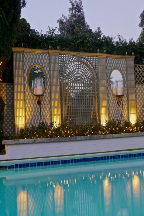 Custom decorative wood treillage by the pool at night. Painted in custom color.  #accentsoffrance #treillage #trellis #latticework #bythepool #residential #frenchartinspiration #savoirfaire Italian Landscaping, Backyard Trellis, Pool At Night, Modern Restaurant Design, Garden Wall Designs, Small Patio Garden, Classic Garden, Trellis Design, Italian Garden