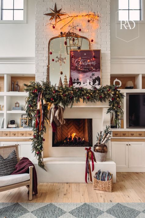 Creating a Whimsical, Woodsy Christmas Mantle for a Cozy Holiday Look Christmas Mantle Stocking Decor, Holiday Interior Decor, Faux Cedar Garland, Tv Mantle, Woodsy Christmas, Mantle Design, Realistic Candles, Cedar Garland, Holiday Interior