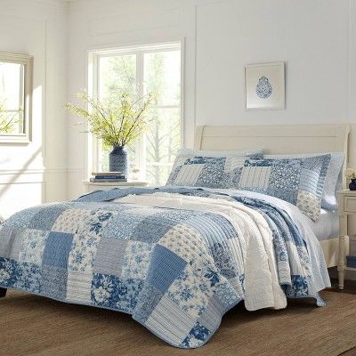 The patchwork features a combination of floral, stripes and paisley print for an overall modern take on a traditional design. The quilt reverses to a vertical white stripe on a blue ground that also binds the quilt. Prewashed for extra softness, the cotton quilt features a polyester fill. Included shams feature an overlap closure. Twin Quilt Set includes: One twin quilt (88"L x 68"W) and one standard sham (21"L x 27"W), Full/Queen Quilt Set includes: One full/queen (90"L x 90"W) and two ... Laura Ashley Bedding, Paisley Quilt, King Quilt Sets, Cotton Quilt Set, Dorm Inspo, College Room, Design Apartment, Quilted Sham, Twin Quilt