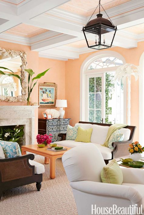 Cantaloupe Living Room To warm up the new Sheetrock interior in a Palm Beach house, the expansive living room is glazed a "juicy cantaloupe color that makes everyone smile," designer Ashley Sharpe says. Even the coffered ceiling subtly picks up the tropical punch. Get this paint color: Benjamin Moore Cantaloupe 157 Peach Living Rooms, Popular Living Room Colors, Good Living Room Colors, Spanish Style Decor, Furnitur Ruang Keluarga, Popular Living Room, Living Room Wall Color, Room Wall Colors, Design Café