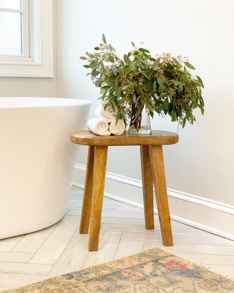 Master bathroom with soaking tub, herringbone marble and a wood stool to keep towels close by. Freestanding Bathtub Side Table, Stool Beside Bathtub, Wood Stool In Bathroom, Wooden Stool In Bathroom, Stool Next To Bathtub, Stool By Tub, Bathroom Stool Styling, Bathtub Stool, Bathroom Stool Decor Ideas