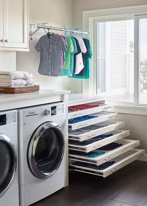 Stacked pull out drying racks are hidden behind white drawer fronts accented with satin nickel pulls and are positioned beneath a drying rod. Laundry Room Drying Rack, Transitional Laundry Room, Sweater Drying Rack, Laundry Room Design Ideas, Drying Room, Stylish Laundry Room, Dream Laundry Room, Laundry Design, Drying Racks