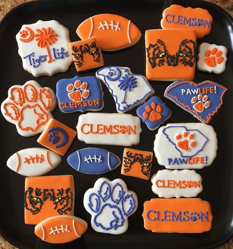 Clemson Tigers cookies #clemson #ClemsonTigers   For more info, specials or to order please visit www.facebook.com/busybeecakery or email me  malinda@busybeecakery.com Clemson Cookies Decorated, Tiger Cookies Decorated, Clemson Graduation Party, Clemson Cookies, Clemson Party, Clemson Tailgate, Football Sugar Cookies, Flood Cookies, Tiger Cookies