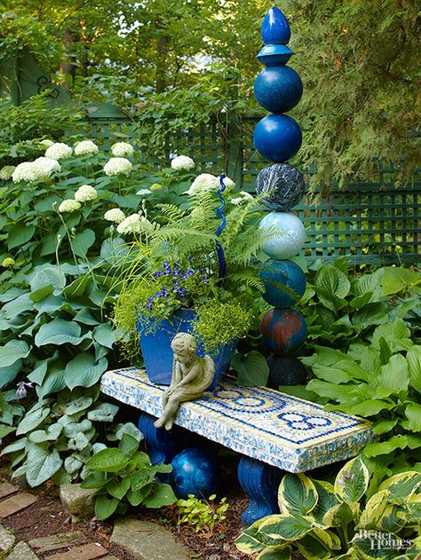 Sometimes, a garden bench isn't really intended for seating. In this space, the small-scale bench works as a colorful accent, offering a pop of blue hues that work well with the decorative structure and planter.