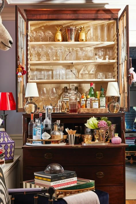 Is Brown Furniture Back? Yes! Here’s How to Style It #purewow #home #home picks #decor Bar Set Up Ideas For Home, Anthro Store Display, Styled Bar Cabinet, Drinks Cabinet Ideas Home Bars, Eclectic Home Bar, Bar Cabinet Styling, Bar Tray Styling, Bar Cabinetry, Bar Dresser