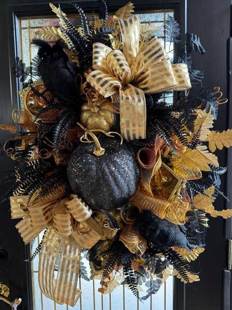 This fall /halloween Glam  wreath is a perfect touch for a door, party decoration, a gift for that special person that loves Halloween. It has a pine base with mesh filler, lots of gold  and black foliage, a  big black sparkling pumkins with smaller gold sparkling pumpkins, bow with coordinating ribbon,  small owls  that accents a   show stopper for sure  but Glamous enough to carry you though til Christmas ! Glam Wreath, Small Owls, Hay Bale Art, Halloween Glam, Deco Mesh Wreaths Diy, Crafty Mom, Small Owl, Mesh Wreath Diy, Halloween Wreaths