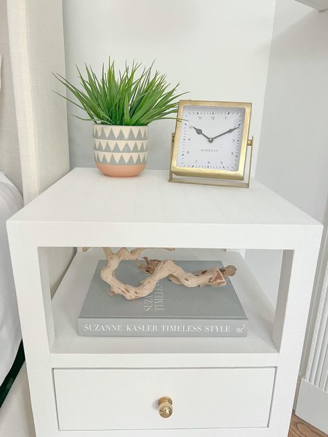 white nightstands with gold clock and coastal decor Hampton Bedroom, Neutral Coastal Decor, White Nightstands, Coastal White, Gold Clock, Coastal Bedrooms, Large Coffee Tables, White Nightstand, Coastal Bedroom