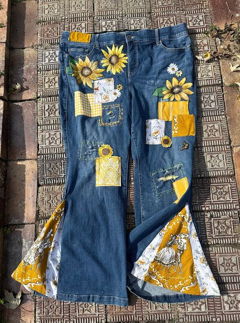 "Made and ready to ship! Groovy Plus size boho bell bottoms.  One of kind! Upcycled Torrid size 24 flare with stretch.  Distressed with patchwork and original art.  Hand painted sunflower and daisies.  The insets on bells I used vintage fabric. Jeans are mid rise with zipper closer. Lots of stretch and comfy. Waist:  46\" Length:  44.5\" Hand or machine wash on cold, delicate and inside out.  Dry on low or fluff to remove wrinkles then hang to dry." Boho Clothing Patterns, Boho Bell Bottoms, Modified Clothing, Diy Jeans Crafts, Fabric Jeans, Jeans Crafts, Yellow Outfits, Clothing Upcycle, Plus Size Fashionista