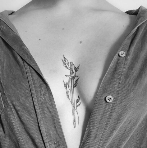 210+ Best Sword Tattoo Designs With Meanings (2022) - TattoosBoyGirl Swords Sternum Tattoo, 96 Tattoo, Women Sternum Tattoo, Tattoo Between Breast, Witcher Tattoo, Look Attractive, Dagger Tattoo, Incredible Tattoos, Sternum Tattoo