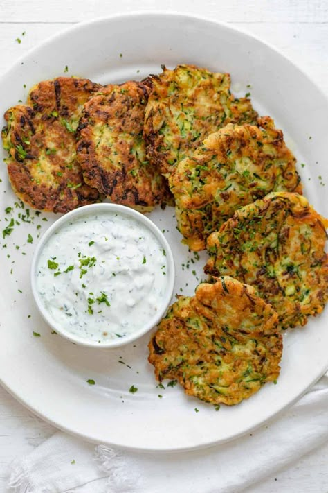 These easy to make Zucchini Fritters make for a great appetizer or side. Wonderfully seasoned, they are a tasty way to get some veggies into your meals! Dinner Zucchini, Zucchini Corn Fritters, Zucchini Fritters Recipe, Feel Good Foodie, Zucchini Pancakes, Homemade Tzatziki Sauce, Salad Aesthetic, Homemade Tzatziki, Zucchini Recipe