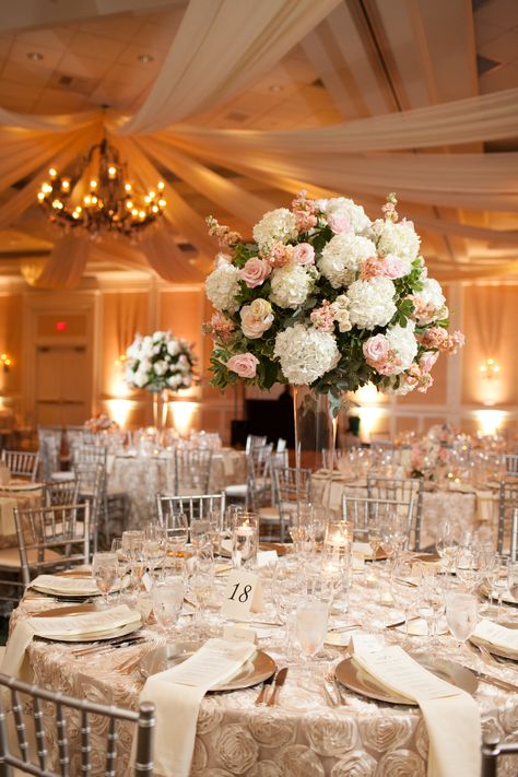 High Centerpiece Wedding Romantic, High And Low Floral Centerpieces, Tall White Rose Wedding Centerpieces, Hydrangea Wedding Centerpieces Tall, Blush And White Tall Centerpiece Wedding, Simple Floral Around Base Tall Centerpeice, Artificial Flower Centerpieces, Groom Wedding Dress, White Flower Arrangements