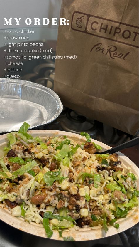 A close-up of a Chipotle bowl filled with extra chicken, brown rice, pinto beans, chili-corn salsa, tomatillo-green chili salsa, cheese, lettuce, and queso. A Chipotle paper bag is visible in the background. Best Chipotle Order, Chipotle Order Ideas Bowl, Best Chipotle Bowl Order, Healthy Chipotle Order, Chipotle Bowl Order Ideas, Chipotle Bowl Order, Chili Corn Salsa, Chipotle Bowls, Chipotle Order