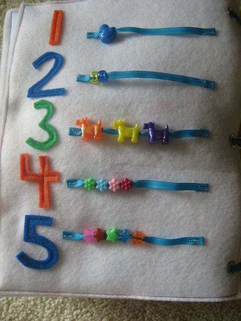 For Numbers, I cut out number shapes in felt and strips of grosgrain ribbon. I strung the matching number of shaped beads on each ribbon strip and stitched the ends so the beads will slide. Diy Quiet Books, Fidget Quilt, Quiet Book Patterns, Quiet Activities, Felt Books, Felt Quiet Books, Felt Book, Soft Book, Quiet Books