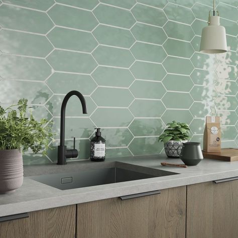 Bring designer style to the home with Picket Green. The range of modern, hexagonal ceramic tiles works well in kitchens and bathrooms, and features a glossy finish with a riven texture. Comes in a 100x300mm size in six stunning pastel shades. Choose from Green, Petal Pink, Sky Blue, Grey, White and Carrara. Kitchen Backsplash Designs, Kitchen Splashback, Kitchen Wall Tiles, Hexagon Tiles, Statement Wall, Bathroom Tiles, Green Tile, Green Kitchen, Kitchen Tiles