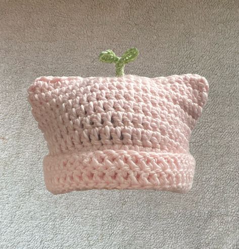 The Pink Sprout Plant Cat Beanie is meant for those who want to add something unique yet adorable to your wardrobe but also convenient for the fast approaching colder months. The plant is made of a cotton and acrylic blend of yarn (60% cotton, 40% acrylic) and the pink beanie part is made up of alpaca and acrylic blend yarn (80% acrylic, 20% alpaca wool), handmade crotched by me. PLEASE READ IN REGARDS TO MATERIALS: Because the pink base of the beanie is made of alpaca wool, there are hairs that Crochet Cat Beanie, Pink Beanie, Cat Beanie, Crochet Business, Crochet Design Pattern, Kawaii Crochet, Beginner Crochet Projects, Pink Crochet, Fun Crochet Projects