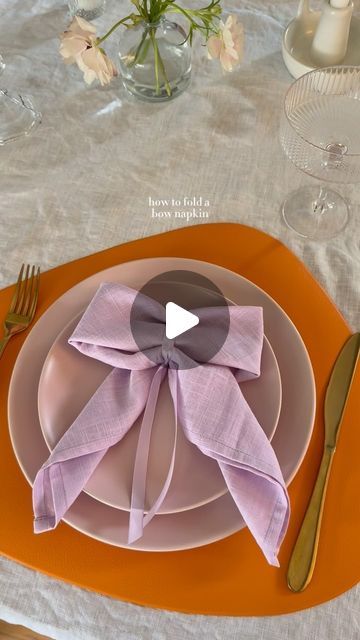 Ashley Tassano on Instagram: "I decided to add this bow napkin last minute, and I’m so happy I did. Not only was it simple, but everyone loved it! You could also make these with a napkin ring or a clear elastic instead of the ribbon.   Tip: Save the ribbon to use again or add it to glassware for your next event. ✨  #coquette #bows #napkinfolding #tablescapes #tablescapestyling #tablescapetuesday #discover" Tea Party Napkin Rings, Paper Napkin Bow, Tying Napkins With Ribbon, Now Napkin Fold, How To Fold A Napkin Into A Bow, Cute Napkin Folds Easy, Bow Napkin Wedding, Napkins Tied With Ribbon, How To Tie Napkins Place Settings