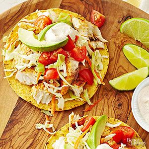 A perfect healthy dinner recipe that costs just over $2 per serving. The combination of sour cream, chili lime cream and tilapia is ready in under 30 minutes. / Tilapia Tostadas, Tostadas Healthy, Fish Tostadas, Tostada Recipe, 20 Minute Dinners, Lime Crema, Inexpensive Dinners, Spicy Cheese, Lime Cream