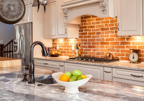 Kitchen with marble countertop island and brick backsplash Cleaning Brick, Traditional Kitchen Remodel, Brick Backsplash Kitchen, How To Clean Brick, Brick Kitchen, Brick Backsplash, Kitchen And Bath Remodeling, Backsplash Kitchen, Kitchen Remodel Design