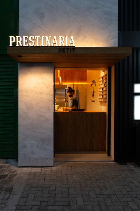 A small bakery makes use of wood dowels with hidden LED lighting to hold up shelving. Small Retail Space, Room Divider Metal, Cafe Design Inspiration, Wood Cafe, Screen Partition, Wayfinding Signage Design, Small Bakery, Small Coffee Shop, Shop Facade