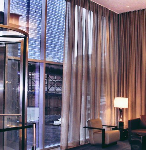 Sheer golden drapes look great in a lobby in midtown Manhattan. #windowtreatments #newyorkcity #officebuilding #office #drapery #interiordesign #homedecor #custom Sheer Curtain Ideas, Curtains Office, Professional Home Office, Modern Sheer Curtains, Glass Wall Office, Office Curtains, Interior Design Curtains, Home Office Design Ideas, Window Curtains Living Room