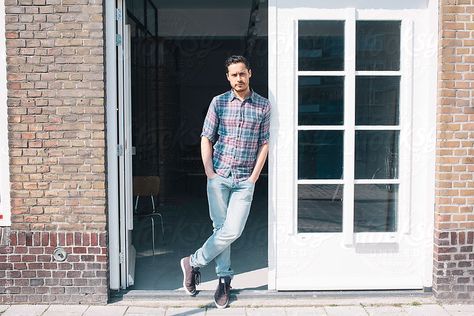 Young man leaning against the door of his office by Ivo de Bruijn #stocksy #realstock Door Lean Pose, Man Leaning Against Door Frame, Leaning Against Door Frame Pose, Becoming Successful, Christian Meditation, Meditation Spirituality, Sleep Deprived, His Office, Pose References