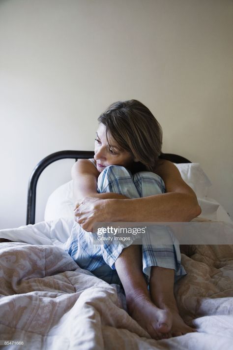 Stock Photo : Woman sitting on bed, hugging knees Person Sitting With Knees To Chest Reference, Sitting Hugging Knees Pose Drawing, Person Hugging Knees Reference, Hugging Knees Pose Reference, Hugging Self Pose, Head On Knees Pose, Person Hugging Knees, Knees Up Pose, Sitting Up In Bed Reference