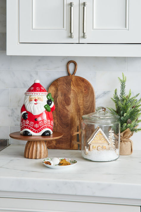 Our magnificently merry Holiday Ceramic Santa Claus Cookie Jar is sculpted of fine ceramic and detailed with jovial red cheeks and a textured snow-white beard. This exclusive holiday collectible features Scandi-style snowflakes and hearts on bright red robes with a green sack of presents over a shoulder. Topped with a conical hat that doubles as an airtight lid, this traditional Christmas gift keeps baked treats fresh and your kitchen decor looking festive. #WorldMarket Christmas Cookie Jars Decoration, Cookie Jar Decor, Traditional Christmas Gifts, Santa Cookie Jar, Christmas Lanterns, Fine Ceramic, Space Decor, Cookie Jars, Fun Decor