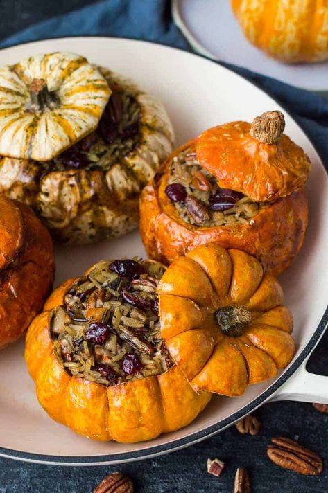 Stuffed mini pumpkins with cranberry and pecan vegetable wild rice in a casserole dish. Vegan and gluten free. Vegetarian Stuffed Pumpkin, Pumpkin Recipes Side Dish, Stuffed Mini Pumpkins, Pecan Rice, Pumpkin Recipes Dinner, Vegan Pumpkin Recipes, Savory Pumpkin Recipes, Vegetarian Entrees, Roasted Butternut