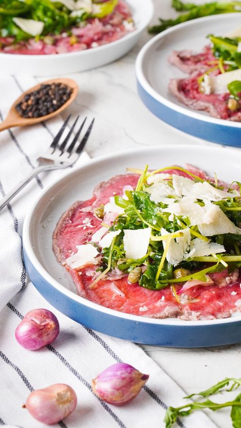 Beef carpaccio is a delicate and sophisticated appetizer. Tender slices of beef tenderloin meld with briny capers, tangy shallots, truffled arugula and savory Parmesan cheese for an impressive dish. Beef Carpaccio Appetizers, Beef Carpaccio Recipe, Carpaccio Recipe, Italian Cooking Class, Beef Carpaccio, Baby Arugula, Beef Tenderloin, Italian Cooking, Parmesan Cheese