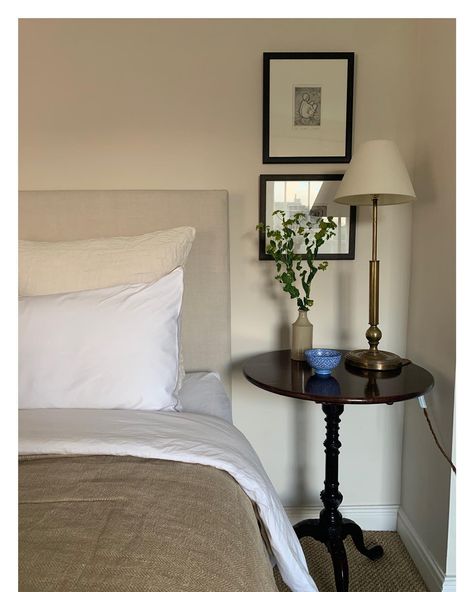 B E D S I D E. I tend to like very simple bedrooms as a calm soft palette is what I find relaxing. Walls painted in #farrowandball #dimity… | Instagram Flowers Ceramic, Soft Palette, Tripod Table, Instagram B, Simple Bedroom, Brass Lamp, Bedtime Stories, Linen Pillows, Wall Paint