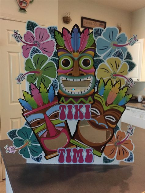 DIY tiki game from all dollar store items. Made for game at Luau party. Object of game is to get hackie sack ball through the tiki men's mouths using a sling shot which was also bought a dollar store. Total spent was $4 to make and pretty easy to assemble. One tri-fold cardboard piece, tiki cutouts, flower cutouts, and glue stick. Tiki Diy Decorations, Tiki Party Decorations, Hawaii Decorations, Tiki Man, Hawaiian Party Theme, Hawaiian Party Decorations, Hawaiian Birthday Party, Sling Shot, Hawaiian Birthday