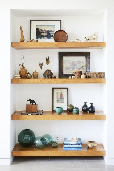 Teak shelves were used in the entryway to display the owners' art collection and souvenirs from abroad. Tagged: Living Room, Shelves, Bookcase, and Storage.  Photo 2 of 12 in This Renovation Will Make You Rethink the Typical Look of a California Beach House Impressive Homes, Teak Shelves, Beach Community, Office Styling, California Beach House, Modern Coastal Home, Indian Living Room, Indian Living Rooms, Coastal Contemporary