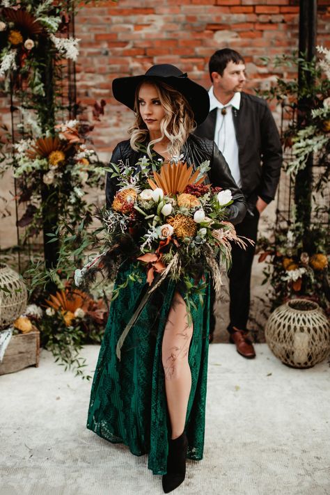 Tones of emerald and sage green. Striking, sleek white accents. And variations of floral in the terra cotta, brown and red rocks of the Grand Canyon. Black is back! And it's the perfect backdrop for this eclectic palette. An off-beat boho bridal bouquet with live cacti, congo grass, sage thistle, orange sun palms, bronze football mums, emerald nagi greens, accents of bleached italian ruscus and sahara cream roses. Emerald Green Wedding Dress Lace, Bleached Italian Ruscus, Lace Wedding Decor, Book Themed Wedding, Top Wedding Trends, Dark Wedding, Sustainable Wedding, Western Aesthetic, Wisconsin Wedding