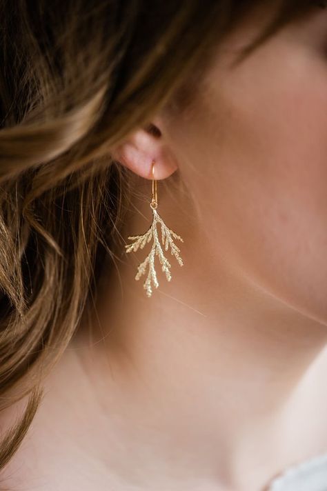 These are beautiful gold spruce branch earrings! The matte gold highlights the details of these nature inspired tree branch earrings. These drop earrings are lightweight and beautifully eye catching! Perfectly pretty and unique gold dangle earrings! These earrings are a great length and measure Delicate Wedding Earrings, Tree Branch Jewelry, Cedar Branch, Spruce Branch, Unique Dangle Earrings, Woodland Earrings, Gold Branches, Cheap Ideas, Branch Earrings