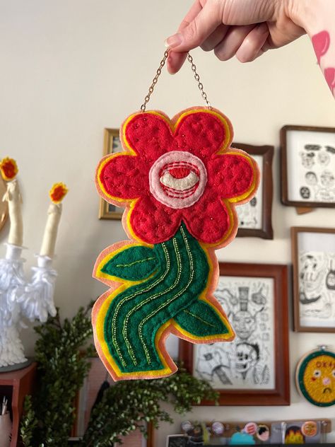 This funky floral wall charm is perfect for any eclectic maximalist gallery wall!  + handmade by me  + 9" x 5.5" with a 2" chain  + made with acrylic felt, seed beads, and embroidery floss Fabric Tapestry Wall Hangings, Embroidery Hanging Wall, Felt Hoop Art, Felt Flower Ornaments, Textile Crafts Ideas, Quirky Wall Decor, Maximalist Crafts, Felt Embroidery Projects, Bright Maximalist Decor