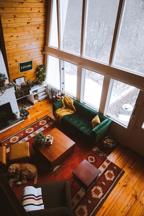 This U Frame cabin in the Catskills is a cozy, rustic but modern space for relaxing in any season. We can't get enough of the dark green velvet couch, the floor to ceiling windows, the mustard yellow accents, and the Southwestern-inspired rugs. Ski Lodge Aesthetic Interior, Eclectic Cabin, Mustard Yellow Accents, Green Velvet Couch, Mountains Cabin, Cabin Core, Perfect Apartment, Angel Fire, Dark Green Velvet