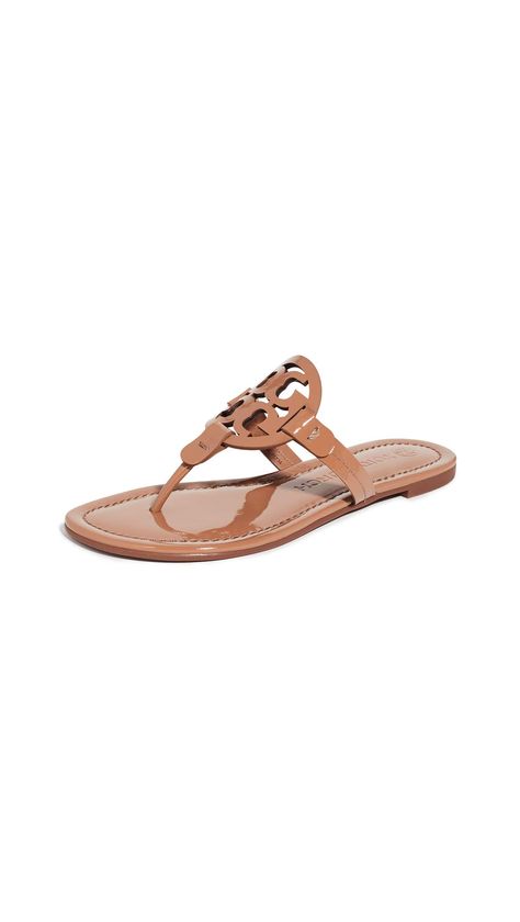 PRICES MAY VARY. Rubber sole Logo cutout Flat profile Open toe An update to one of the label's signature styles, these Tory Burch sandals are crafted from glossy patent leather and feature a prominent logo cutout for an elevated addition to all your casual summer ensembles. Tory Burch Sandals Outfit, Tory Burch Flip Flops, Signature Styles, Tory Burch Sandals, Sandals Outfit, Girly Shoes, Embellished Sandals, Tory Burch Miller, Tory Burch Miller Sandal