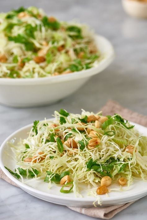 This crunchy cabbage and peanut slaw recipe makes for a great side dish because you only have to combine a few easy ingredients. The combo of cabbage, peanuts, and rice vinegar with oil is one you won't forget. Additional ingredients include fresh cilantro, salt and pepper, granulated sugar and soy sauce. Peanut Slaw Recipe, Peanut Slaw, Side Dishes For Salmon, Dinners Recipes, Quick Food, Easy Vegetarian Dinner, Slaw Recipes, Raw Vegetables, Vegetarian Dinners