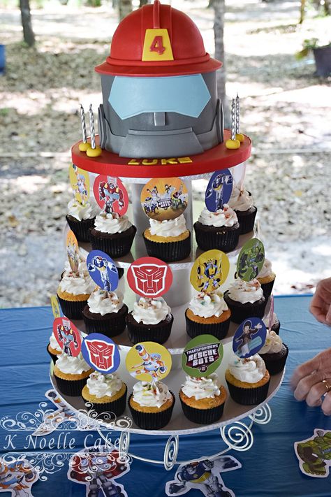 Rescue Bots cake and cupcakes by K Noelle Cakes Birthday Cake Transformers, Rescue Bots Cake, Vehicle Cake, Rescue Bots Birthday Party, Rescue Bots Party, Rescue Bots Birthday, Transformers Party, Transformers Cake, Transformers Birthday Parties