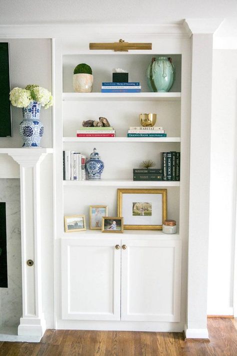 how to style builtins around your fireplace Lights In Built In Shelves, Blue Built Ins Fireplace, Light Over Built Ins, Light Over Bookcase, Picture Light Over Shelves, Picture Light Over Bookcase, Wallpaper On Built In Shelves, Picture Lights Bookcase, Picture Light Bookcase