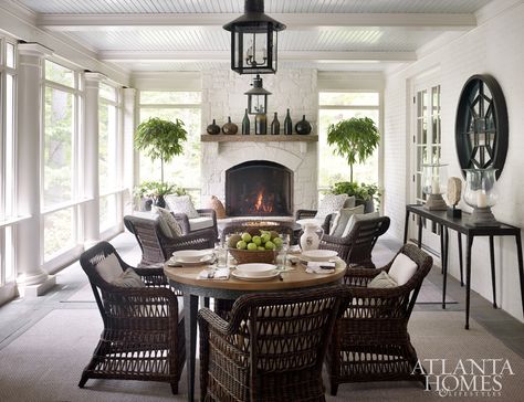 When the couple purchased the house, the porch had the feeling of one in the mountains, with a stone fireplace and dark, hand-hewn beams. Litchfield added a beadboard ceiling and box beams, and Lanham brightened the space with white paint. He also designed a breezeway that leads from the porch to the pool to balance the back elevation Modern Sunroom, Seasonal Room, Porch Fireplace, Sunroom Decorating, Small Fireplace, European Home Decor, Painted Stone, Atlanta Homes, Fireplace Ideas