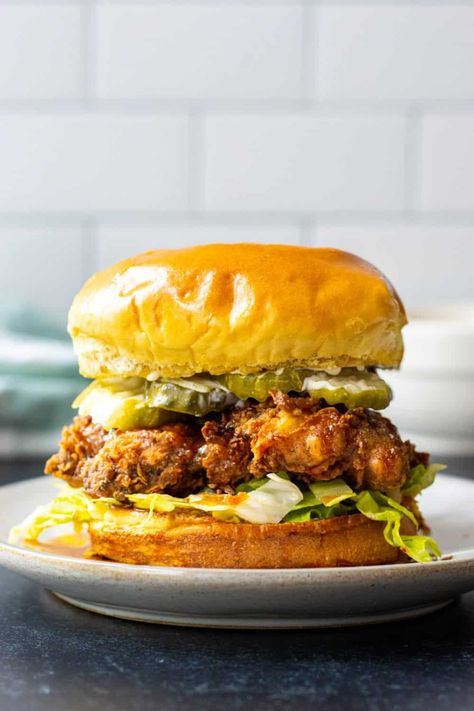 Crispy fried chicken thighs drizzled with hot honey sauce then nestled between crunchy lettuce and pickles on a toasted brioche bun. Hot Honey Chicken Sandwich, Honey Chicken Sandwich, Creamy Parmesan Rice, Zucchini Pasta Salad, Crispy Chicken Sandwich, Hot Honey Chicken, Chicken Sandwich Recipe, Crispy Chicken Sandwiches, Crispy Chicken Thighs