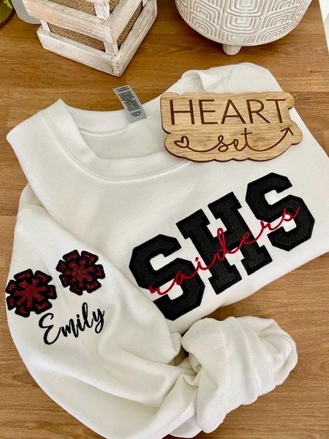 ** Please read before buying **  Personalized Embroidered School Spirit sweatshirt with glitter HTV applique. Fit: Unisex, Fits loose/relaxed Sizing: S,M,L,XL,2XL Material: 50% Cotton, 50% Polyester Embroidery Details: School initials with mascot name centered across the chest Pom pom's and with personalized name on right shoulder sleeve *If you don't see what you're looking for please message me. :)  PROCESSING/TURNAROUND TIME: -Processing/Turn around times may vary. Please check the estimated Cheer Jackets, Varsity Cheer, Cheerleading Shirts, Cheer Mom Shirts, Team Sweatshirts, Football Mom Shirts, Cheer Shirts, Cheer Mom, Sports Sweatshirts