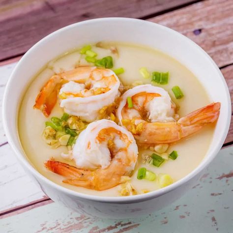 A soft , comforting and tasty preparation of steamed egg custard topped with shrimps and seasoning.Chinese steamed egg with shrimp; this is an easy healthy dish. Take less than 10 minutes to make and it is soft like pudding. Very delicious.Steamed egg custard is a beloved everyday dish in China. The smooth custard is easy to make and incredibly pleasurable and comforting. It’s arguably one of the first dishes that many Chinese learn to cook when they’re young, inevitably becoming an old standby Korean Steamed Egg, Steamed Egg Custard, Chinese Learn, Shrimp Appetizer Recipes, Shrimp Appetizer, Shrimp And Eggs, Steamed Eggs, Shrimp Appetizers, Egg Custard